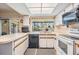 Bright kitchen features modern appliances, white cabinetry and a garden window at 8956 124Th Way, Seminole, FL 33772