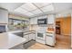 Bright kitchen features recessed lighting and a garden view at 8956 124Th Way, Seminole, FL 33772