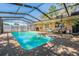 Sparkling pool with covered seating area, perfect for relaxing and entertaining outdoors at 8956 124Th Way, Seminole, FL 33772