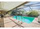 Enclosed pool with ample deck space for entertaining, surrounded by mature landscaping at 8956 124Th Way, Seminole, FL 33772