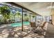 Screened-in pool area with outdoor seating surrounded by lush landscaping at 8956 124Th Way, Seminole, FL 33772
