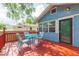 Enjoy the outdoor living space on this vibrant back deck with a dining table and chairs at 904 E Patterson St, Tampa, FL 33604