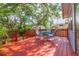 Relax on this vibrant back deck with a dining table and chairs surrounded by trees at 904 E Patterson St, Tampa, FL 33604