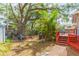 Lush backyard featuring a deck, mature trees, a firepit, and outdoor space at 904 E Patterson St, Tampa, FL 33604