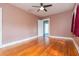 Bedroom with hardwood floors, ceiling fan, and door into another room at 904 E Patterson St, Tampa, FL 33604