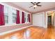 Bedroom with hardwood floors, ceiling fan, and a closet with doors at 904 E Patterson St, Tampa, FL 33604