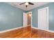 Bedroom with hardwood floors, ceiling fan, and a closet with doors and a door at 904 E Patterson St, Tampa, FL 33604