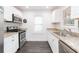 Updated kitchen with stainless steel appliances, granite countertops, and subway tile backsplash at 904 E Patterson St, Tampa, FL 33604
