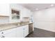 Updated kitchen with granite countertops, stainless steel dishwasher and subway tile backsplash at 904 E Patterson St, Tampa, FL 33604