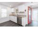 Bright kitchen featuring white cabinets, stainless steel appliances, and granite countertops at 904 E Patterson St, Tampa, FL 33604