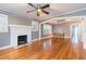 Open living room featuring hardwood floors, a brick fireplace, neutral paint, and an archway at 904 E Patterson St, Tampa, FL 33604