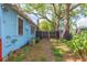 Cozy home exterior with lush side yard and convenient access to the backyard at 904 E Patterson St, Tampa, FL 33604