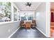 Sun room features dark floors, three windows, ceiling fan, and wicker chairs at 904 E Patterson St, Tampa, FL 33604