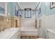 Bright bathroom featuring a shower-tub combo, and classic tile at 916 E Broad St, Tampa, FL 33604