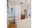 A bedroom featuring hardwood floors, a bright white closet and a modern storage chest at 916 E Broad St, Tampa, FL 33604