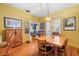 Bright dining room featuring hardwood floors, a large dining table, and seamless access to other living spaces at 916 E Broad St, Tampa, FL 33604