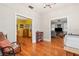 Spacious room with beautiful wood floors and decorative light fixture, seamlessly connecting to the living area at 916 E Broad St, Tampa, FL 33604