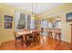 Charming dining room boasting hardwood floors, a stylish light fixture, and views into the kitchen and living spaces at 916 E Broad St, Tampa, FL 33604