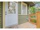Charming entryway featuring painted siding, white trim, and wood plank porch at 916 E Broad St, Tampa, FL 33604