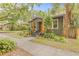 Quaint home with lush front yard, inviting front porch, and mature landscaping at 916 E Broad St, Tampa, FL 33604