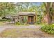 Charming home with covered parking, lush landscaping, and welcoming front porch at 916 E Broad St, Tampa, FL 33604