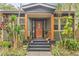 Charming front porch with wood columns and decorative plants, creating a welcoming entrance to the home at 916 E Broad St, Tampa, FL 33604
