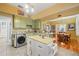 The kitchen features granite countertops, green cabinets, stainless steel sink, island and modern stainless steel washer at 916 E Broad St, Tampa, FL 33604
