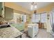 Spacious kitchen with eat-in nook, kitchen island, granite countertops, green cabinets and tile flooring at 916 E Broad St, Tampa, FL 33604