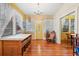 Living room featuring hardwood floors, an decorative chandelier, bright yellow door and ample natural light at 916 E Broad St, Tampa, FL 33604