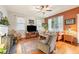 Comfortable living room with hardwood floors, a ceiling fan, and ample natural light from the large windows at 916 E Broad St, Tampa, FL 33604