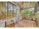 Inviting sunroom with wood floors and tranquil views at 916 E Broad St, Tampa, FL 33604