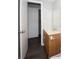 Cozy bathroom featuring a wood vanity, mirror, and an open doorway at 9816 Crofton Ln, Port Richey, FL 34668