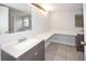 Bathroom with double vanity, expansive countertop space, and tile flooring at 9816 Crofton Ln, Port Richey, FL 34668