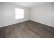 Neutral bedroom with wood floors, natural light, and freshly painted walls at 9816 Crofton Ln, Port Richey, FL 34668