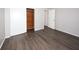 Bedroom featuring hardwood-style floors and a closet space at 9816 Crofton Ln, Port Richey, FL 34668