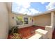 Welcoming front entrance with covered porch, attractive landscaping, and brick paved walkway at 9816 Crofton Ln, Port Richey, FL 34668