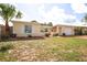 Charming single-story home featuring a well-kept lawn and mature palm tree at 9816 Crofton Ln, Port Richey, FL 34668