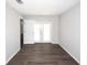 Bright living room with modern flooring and double doors leading to outdoor space at 9816 Crofton Ln, Port Richey, FL 34668
