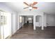 View of the living room with laminate floors featuring an archway and ceiling fan at 9816 Crofton Ln, Port Richey, FL 34668