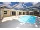 Screened pool with clear blue water, patio area, and an enclosed patio at 9816 Crofton Ln, Port Richey, FL 34668