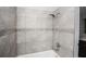 Recently renovated shower with decorative tile, chrome fixtures, and neutral palette at 9816 Crofton Ln, Port Richey, FL 34668