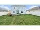 Backyard featuring a green lawn, a fire pit, and a fence at 3509 San Moise St, Plant City, FL 33567