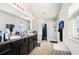 Bathroom features a double vanity, tile floor, and a shower with curtain at 3509 San Moise St, Plant City, FL 33567