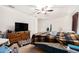 Bedroom featuring a dresser, ceiling fan, and bed with a patterned blanket at 3509 San Moise St, Plant City, FL 33567