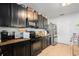 Functional kitchen features dark cabinetry, modern appliances, and granite countertops at 3509 San Moise St, Plant City, FL 33567