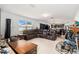 Open living area featuring neutral tile floors, comfortable seating, and natural light at 3509 San Moise St, Plant City, FL 33567