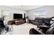 Comfortable living room with large windows, neutral tile flooring, and a plush sectional at 3509 San Moise St, Plant City, FL 33567