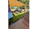 Cozy backyard patio featuring artificial turf, patio set, grill, and sunshade at 10411 Summerview Cir, Riverview, FL 33578