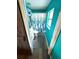 Narrow bathroom features cool-toned walls, white fixtures and vanity, and unique wood-look flooring at 10411 Summerview Cir, Riverview, FL 33578