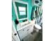 Bright bathroom featuring a clean white vanity and a serene turquoise wall color at 10411 Summerview Cir, Riverview, FL 33578
